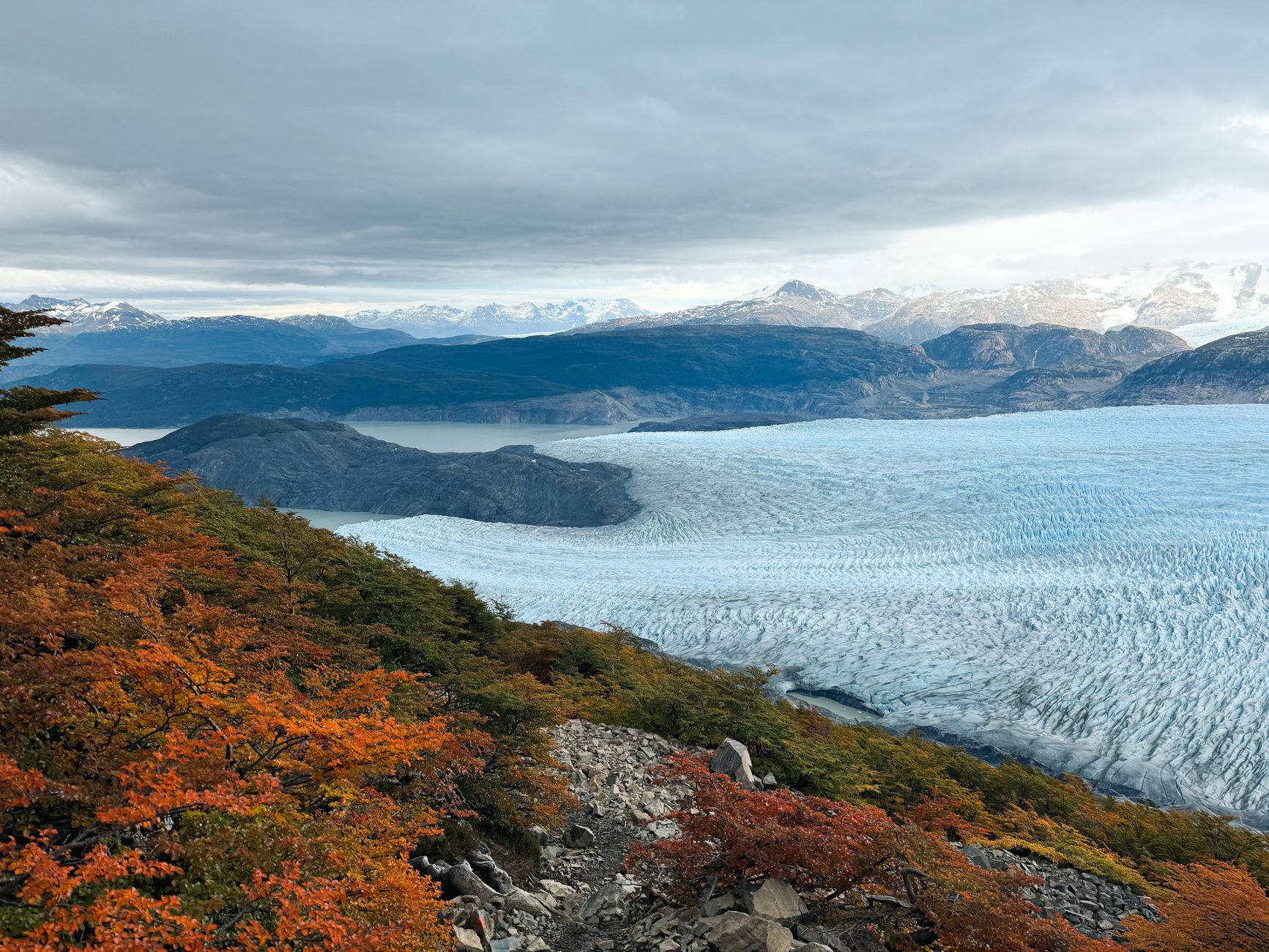 Patagonian mountain glacier melting into deep turquoise lake